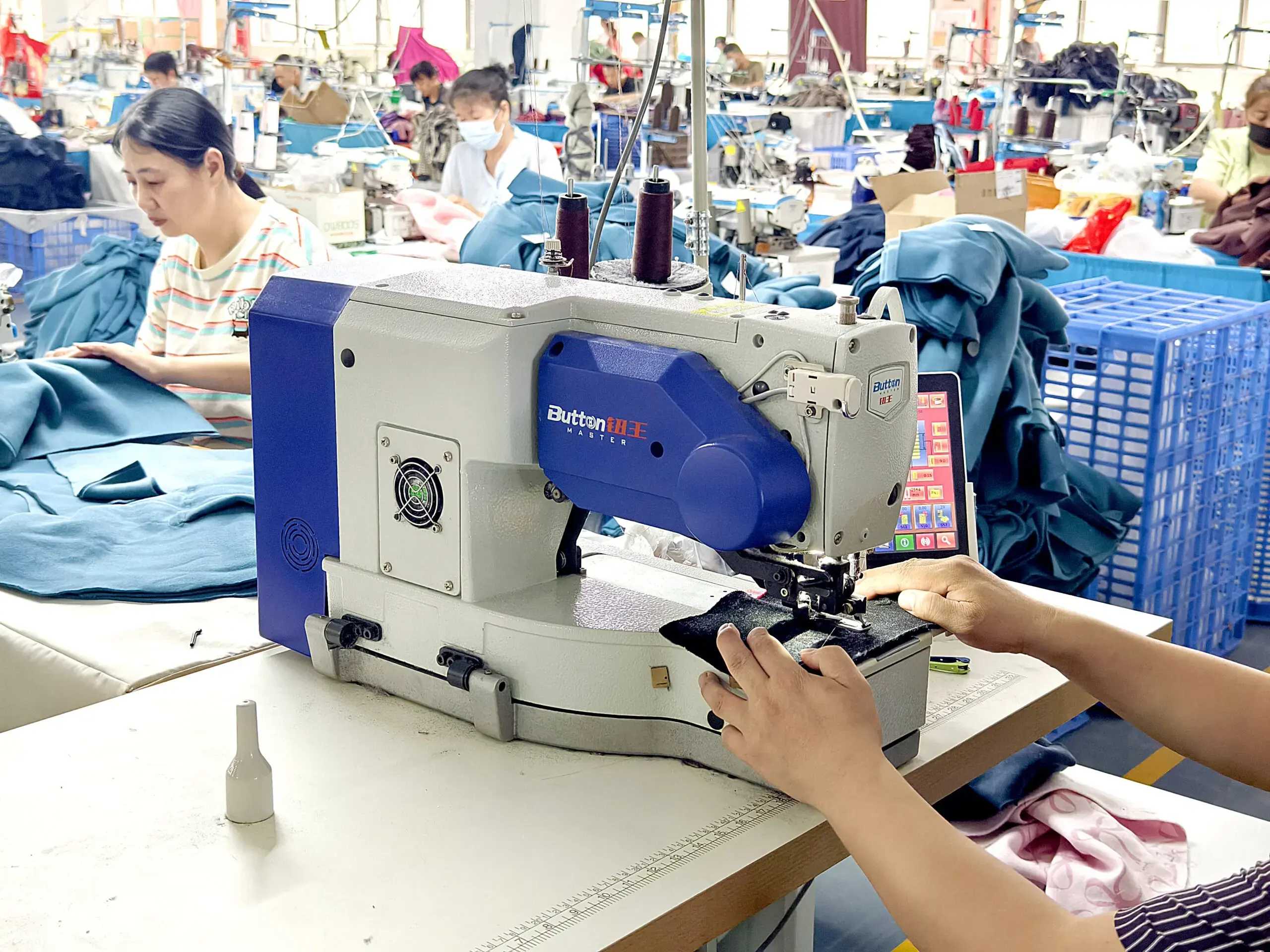 OEM/ODM clothing manufacturer reference: Industrial sewing machine and operators assembling garments
