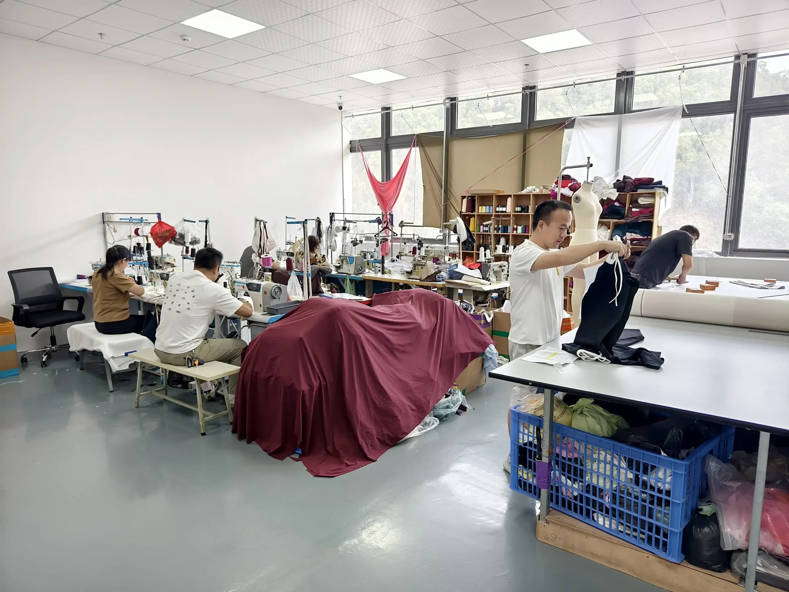Technical review of knitwear tech packs on the production floor at Shijin Fashion