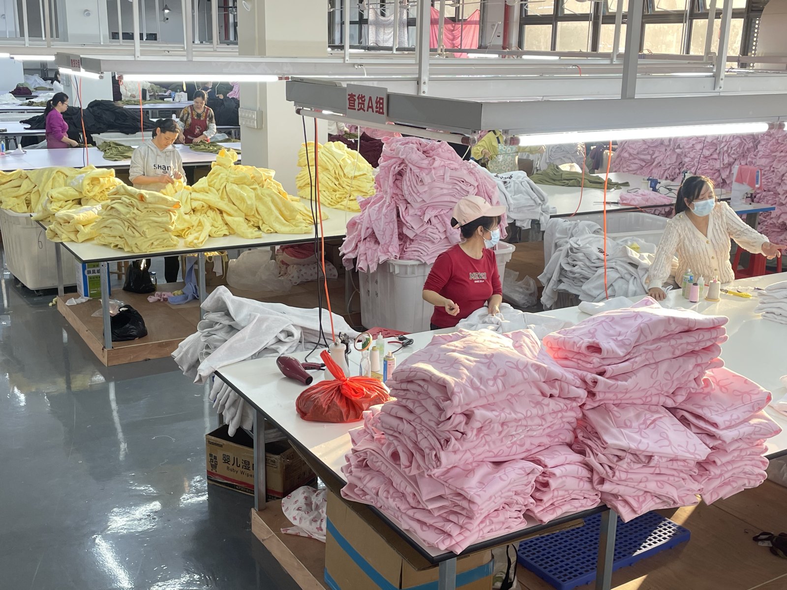 Garments arranged on worktables during production processing.