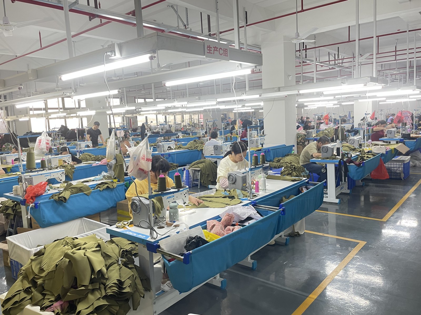 Sewing workstations and operators on the garment production floor.